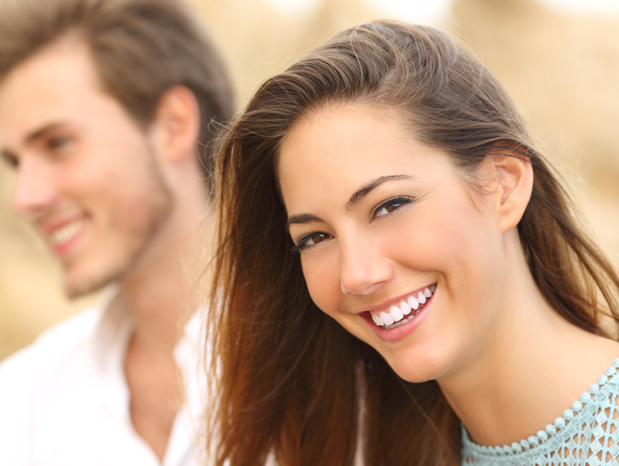 woman smiles knowing she made the right decision between invisalign vs suresmile